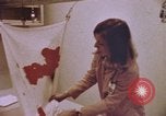 Image of blood stained clothing United States USA, 1969, second 8 stock footage video 65675075429