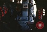 Image of U.S. and Montagnard troops parachute from CH-3E helicopter Vietnam, 1967, second 8 stock footage video 65675075610