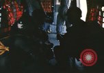 Image of U.S. and Montagnard troops parachute from CH-3E helicopter Vietnam, 1967, second 13 stock footage video 65675075610