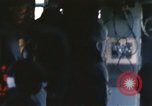 Image of U.S. and Montagnard troops parachute from CH-3E helicopter Vietnam, 1967, second 33 stock footage video 65675075610