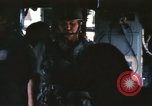 Image of U.S. and Montagnard troops parachute from CH-3E helicopter Vietnam, 1967, second 35 stock footage video 65675075610