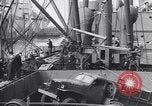 Image of Transport ships being loaded with troops and supplies for invasion task force United States USA, 1944, second 38 stock footage video 65675075793