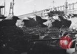 Image of Transport ships being loaded with troops and supplies for invasion task force United States USA, 1944, second 42 stock footage video 65675075793
