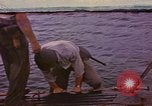 Image of US Sailors leave submarine and go ashore in life raft Japan, 1945, second 1 stock footage video 65675076035