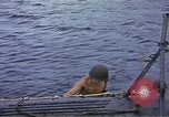 Image of US Sailors leave submarine and go ashore in life raft Japan, 1945, second 10 stock footage video 65675076035