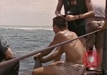 Image of Submarine, USS Cod, rescuing crew of Dutch submarine, O-19 Spratly Islands, 1945, second 61 stock footage video 65675076085