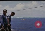 Image of USS Cod (SS-224) rescuing crew from Dutch submarine (O-19) Spratly Islands, 1945, second 16 stock footage video 65675076087