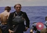 Image of USS Cod (SS-224) rescuing crew from Dutch submarine (O-19) Spratly Islands, 1945, second 43 stock footage video 65675076087