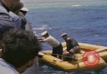 Image of USS Cod (SS-224) rescuing crew from Dutch submarine (O-19) Spratly Islands, 1945, second 62 stock footage video 65675076087