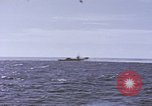 Image of USS Cod fires deck gun in actions to scuttle Dutch submarine, O-19 Spratly Islands, 1945, second 3 stock footage video 65675076091