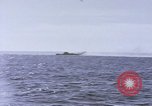 Image of USS Cod fires deck gun in actions to scuttle Dutch submarine, O-19 Spratly Islands, 1945, second 27 stock footage video 65675076091
