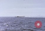 Image of USS Cod fires deck gun in actions to scuttle Dutch submarine, O-19 Spratly Islands, 1945, second 46 stock footage video 65675076091