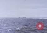 Image of USS Cod fires deck gun in actions to scuttle Dutch submarine, O-19 Spratly Islands, 1945, second 57 stock footage video 65675076091