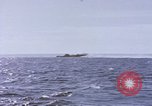 Image of USS Cod fires deck gun in actions to scuttle Dutch submarine, O-19 Spratly Islands, 1945, second 58 stock footage video 65675076091