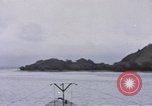 Image of American submarine waits in bay for commandos Pacific Theater, 1944, second 17 stock footage video 65675076122