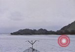 Image of American submarine waits in bay for commandos Pacific Theater, 1944, second 20 stock footage video 65675076122
