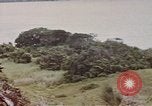 Image of US commandos set explosives on island Pacific Theater, 1944, second 57 stock footage video 65675076123