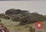 Image of US commandos set explosives on island Pacific Theater, 1944, second 58 stock footage video 65675076123