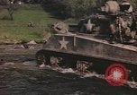 Image of U.S. troops ride on tanks crossing a stream Germany, 1945, second 5 stock footage video 65675076625