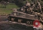 Image of U.S. troops ride on tanks crossing a stream Germany, 1945, second 6 stock footage video 65675076625