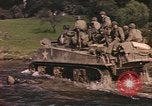 Image of U.S. troops ride on tanks crossing a stream Germany, 1945, second 8 stock footage video 65675076625