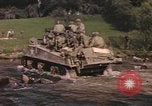 Image of U.S. troops ride on tanks crossing a stream Germany, 1945, second 10 stock footage video 65675076625