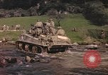 Image of U.S. troops ride on tanks crossing a stream Germany, 1945, second 12 stock footage video 65675076625