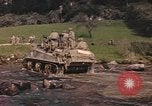 Image of U.S. troops ride on tanks crossing a stream Germany, 1945, second 13 stock footage video 65675076625