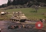 Image of U.S. troops ride on tanks crossing a stream Germany, 1945, second 16 stock footage video 65675076625