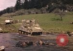 Image of U.S. troops ride on tanks crossing a stream Germany, 1945, second 17 stock footage video 65675076625
