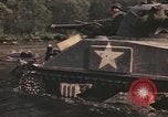 Image of U.S. troops ride on tanks crossing a stream Germany, 1945, second 41 stock footage video 65675076625