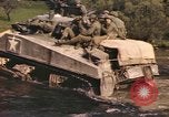Image of U.S. troops ride on tanks crossing a stream Germany, 1945, second 49 stock footage video 65675076625