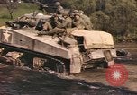 Image of U.S. troops ride on tanks crossing a stream Germany, 1945, second 50 stock footage video 65675076625