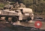 Image of U.S. troops ride on tanks crossing a stream Germany, 1945, second 51 stock footage video 65675076625