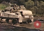 Image of U.S. troops ride on tanks crossing a stream Germany, 1945, second 52 stock footage video 65675076625