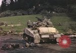 Image of U.S. troops ride on tanks crossing a stream Germany, 1945, second 53 stock footage video 65675076625