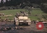 Image of U.S. troops ride on tanks crossing a stream Germany, 1945, second 56 stock footage video 65675076625