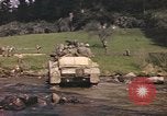 Image of U.S. troops ride on tanks crossing a stream Germany, 1945, second 58 stock footage video 65675076625