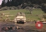Image of U.S. troops ride on tanks crossing a stream Germany, 1945, second 62 stock footage video 65675076625