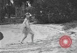 Image of Boy dressed in grass skirt performs hula dance Fort Lauderdale Florida USA, 1920, second 9 stock footage video 65675076871