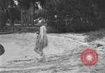 Image of Boy dressed in grass skirt performs hula dance Fort Lauderdale Florida USA, 1920, second 10 stock footage video 65675076871