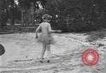 Image of Boy dressed in grass skirt performs hula dance Fort Lauderdale Florida USA, 1920, second 21 stock footage video 65675076871
