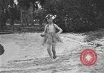 Image of Boy dressed in grass skirt performs hula dance Fort Lauderdale Florida USA, 1920, second 33 stock footage video 65675076871