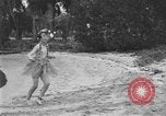 Image of Boy dressed in grass skirt performs hula dance Fort Lauderdale Florida USA, 1920, second 34 stock footage video 65675076871