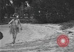 Image of Boy dressed in grass skirt performs hula dance Fort Lauderdale Florida USA, 1920, second 37 stock footage video 65675076871