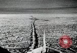 Image of USS Burton Island breaking way through ice in Bering Sea Bering Sea, 1952, second 14 stock footage video 65675077436