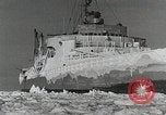 Image of USS Burton Island breaking way through ice in Bering Sea Bering Sea, 1952, second 42 stock footage video 65675077436