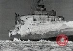 Image of USS Burton Island breaking way through ice in Bering Sea Bering Sea, 1952, second 44 stock footage video 65675077436