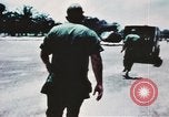 Image of medical aid via Huey helicopter and ambulance Vietnam, 1966, second 12 stock footage video 65675077440
