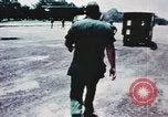 Image of medical aid via Huey helicopter and ambulance Vietnam, 1966, second 14 stock footage video 65675077440